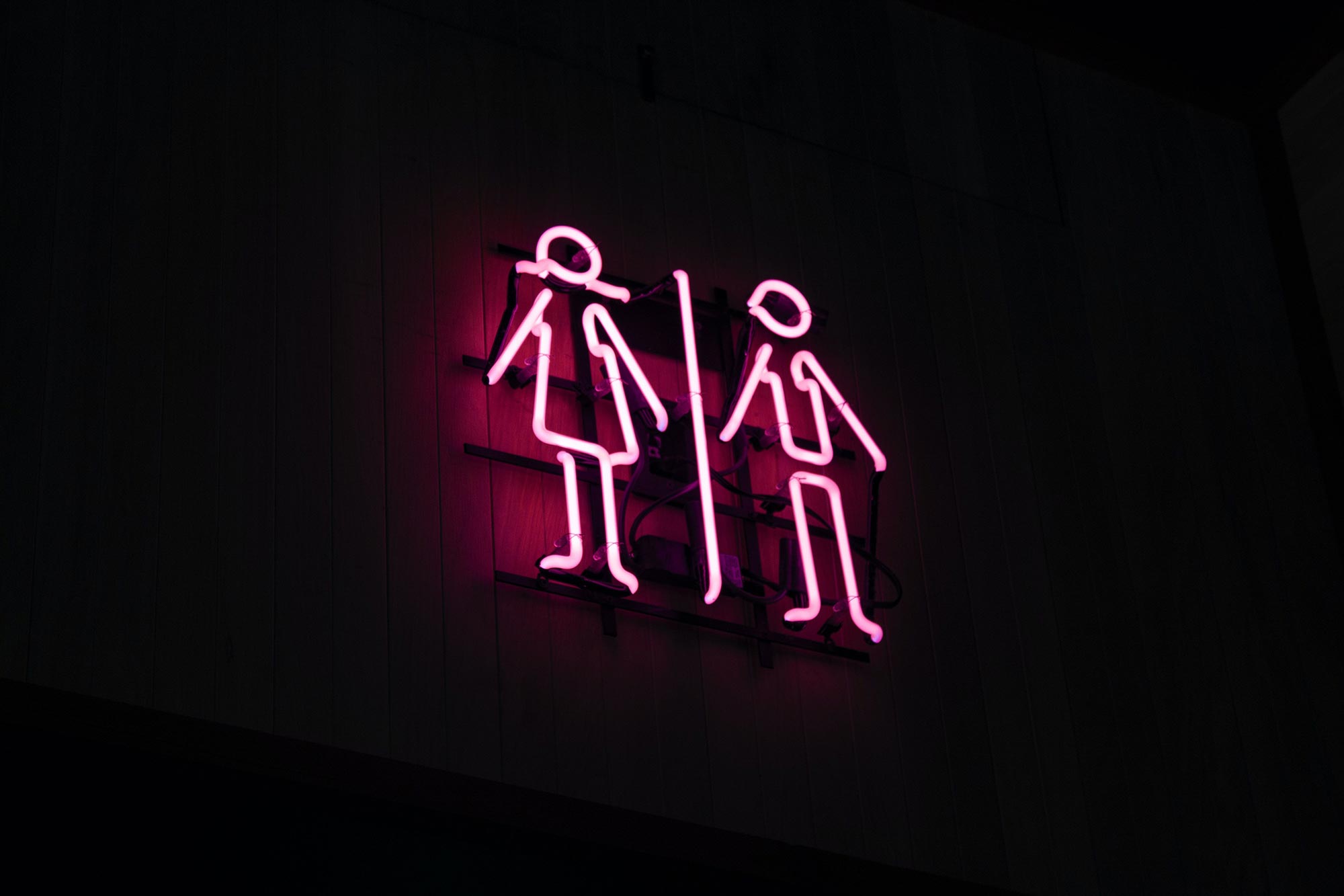 neon sign depicting masculine and feminine stick figures