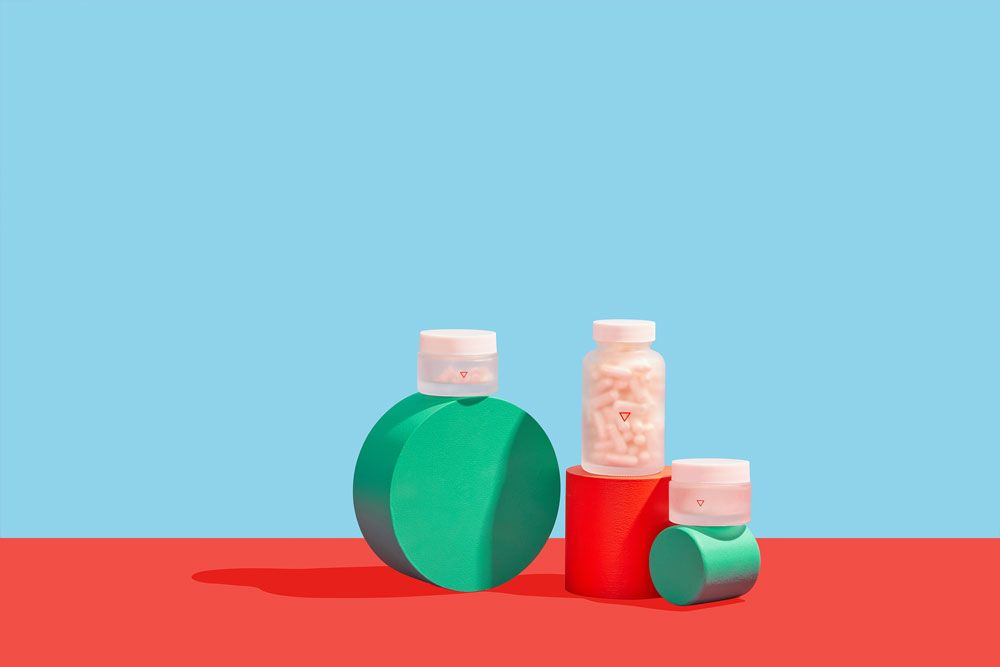Various pills in Wisp glass jars on colorful geometric background
