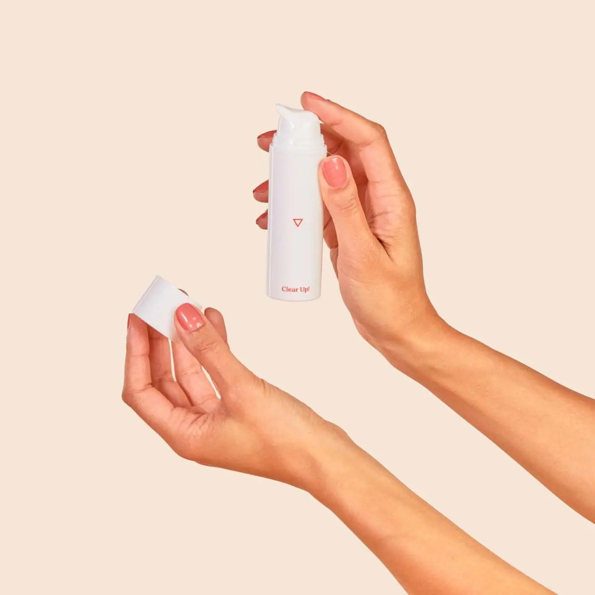 Clear Up! Acne Cream on a in a person's hand with a beige background