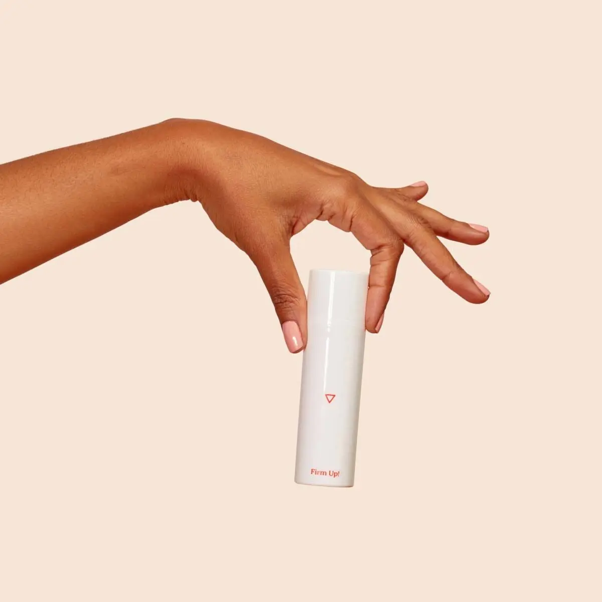 Firm Up! Wrinkle Firming Cream in a person's hand with a beige background