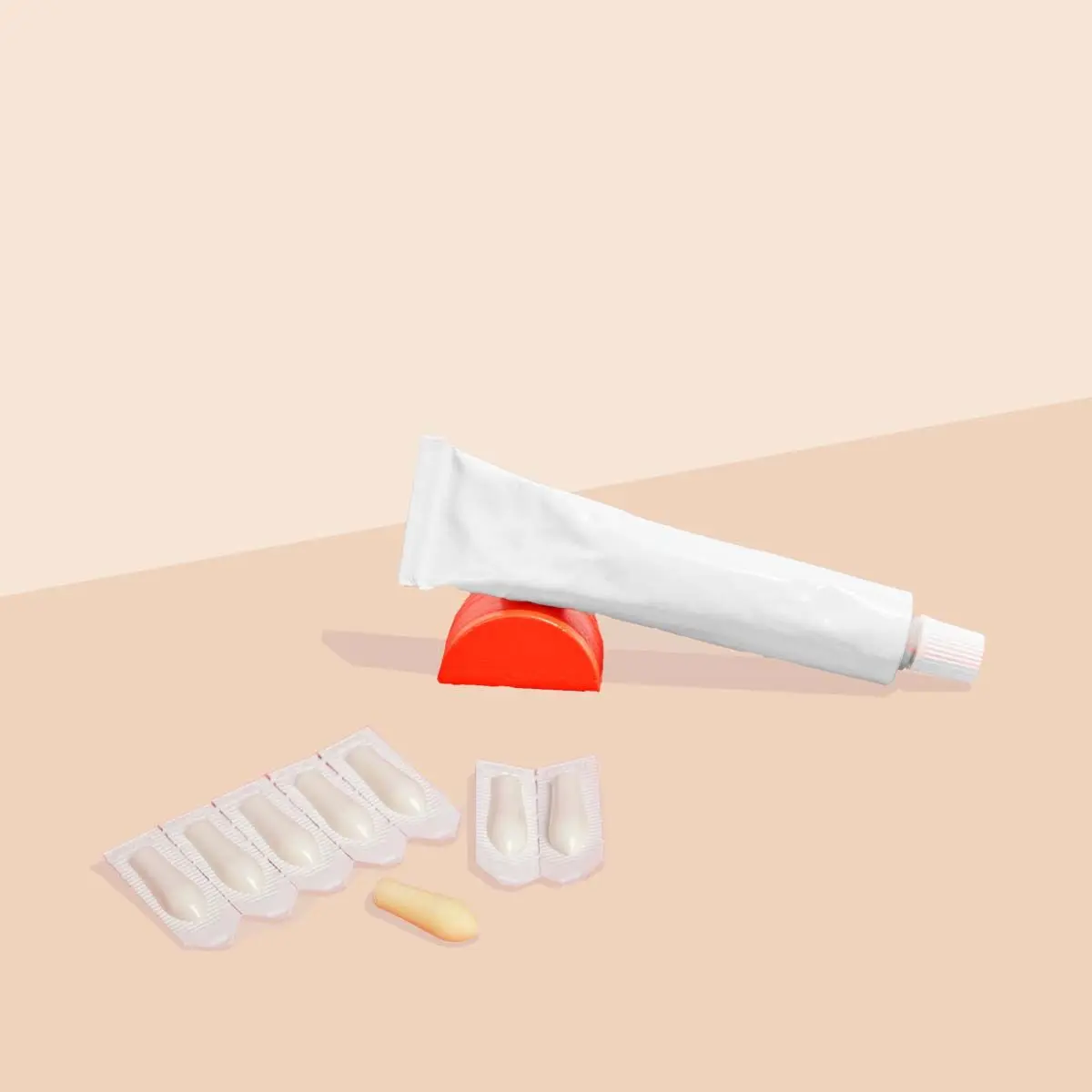 Topical and suppository hemorrhoid treatment on a cream surface