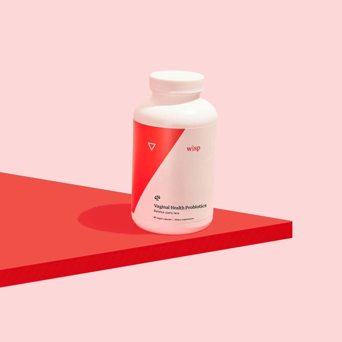 Wisp Vagina Probiotics on a red surface with a pink background