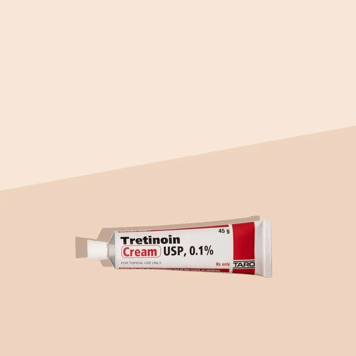 A tube of Tretinoin on a cream surface