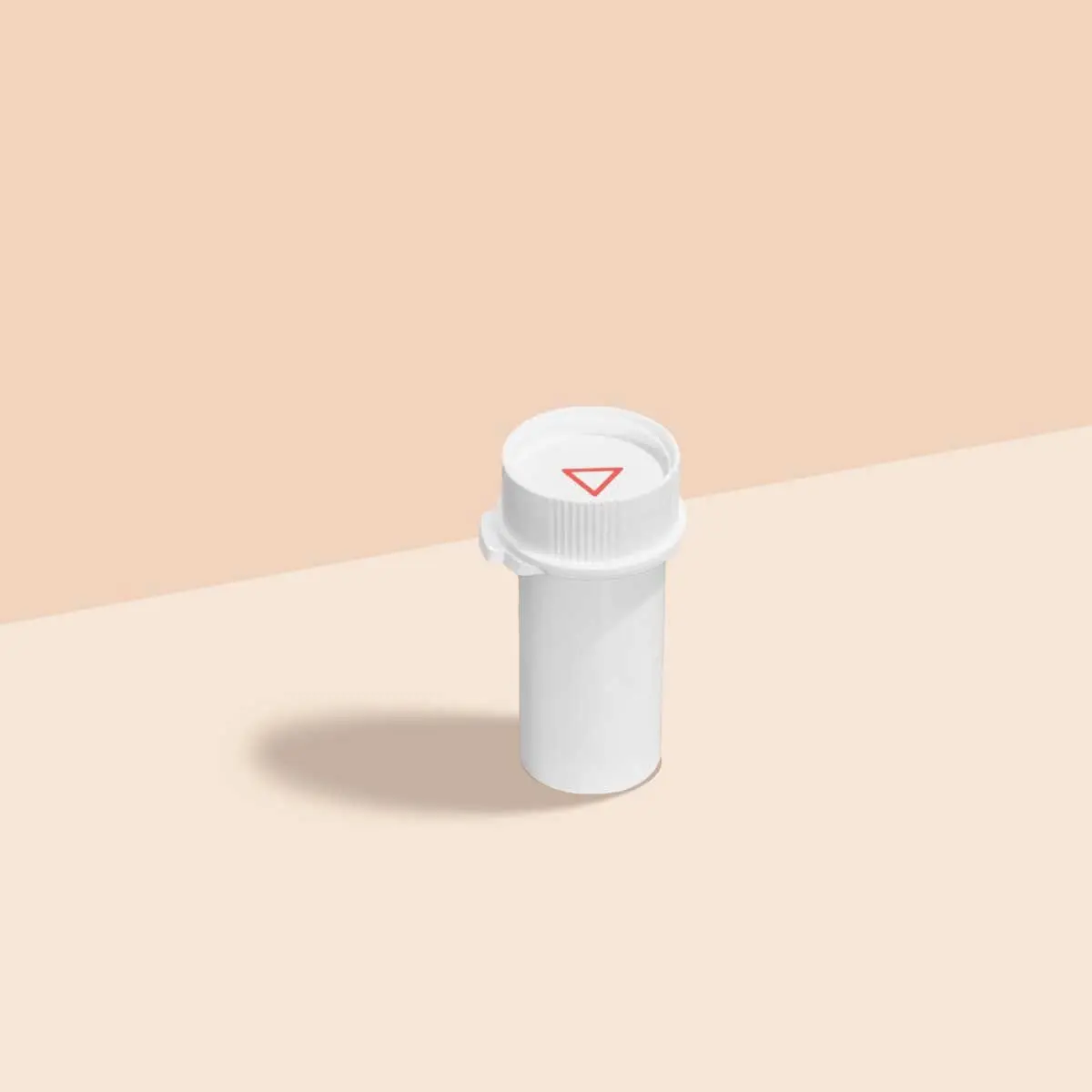 A Wisp pill vial on a cream surface